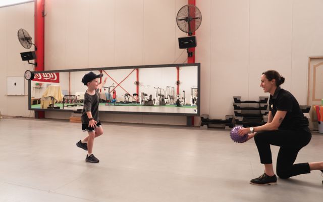 Grace working with a young patient on balance